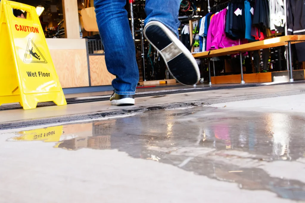 A person slipping on a wet floor.