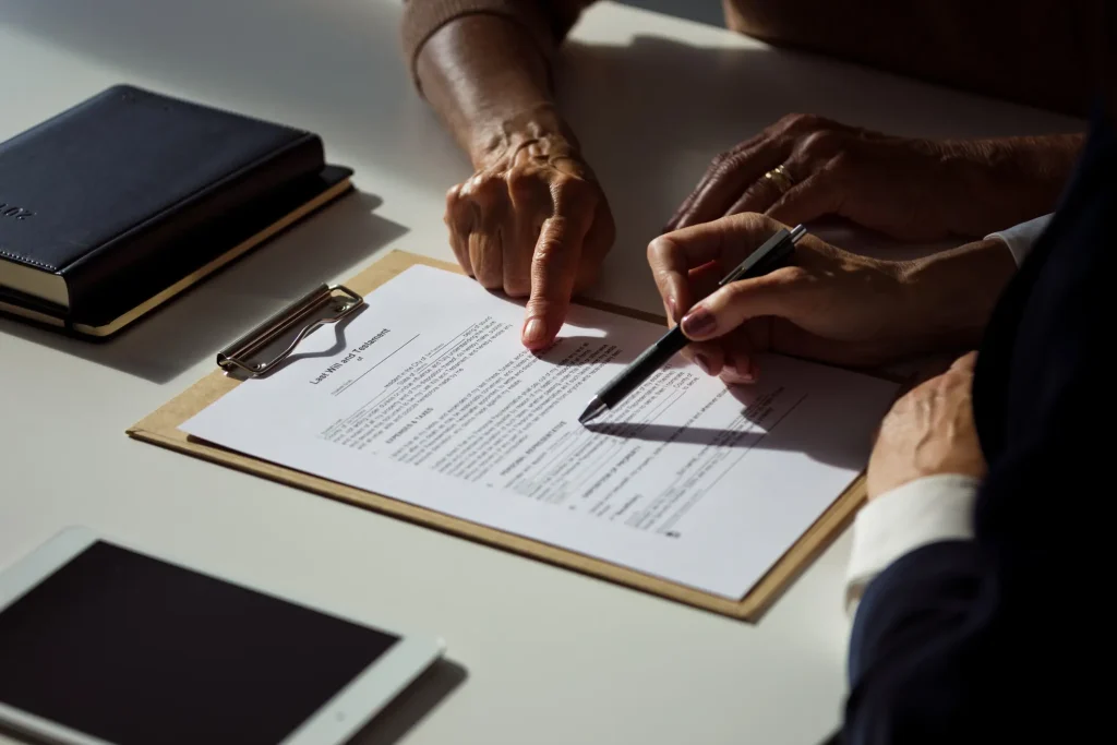 A person telling another person where to sign on the document. 