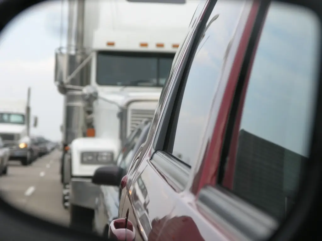 A truck rear ending a car.