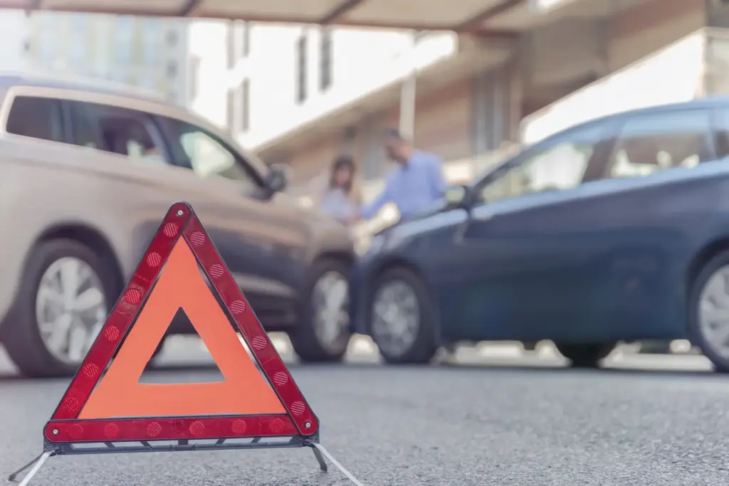 A head on collision accident with two people trying to figure out what is going on. 