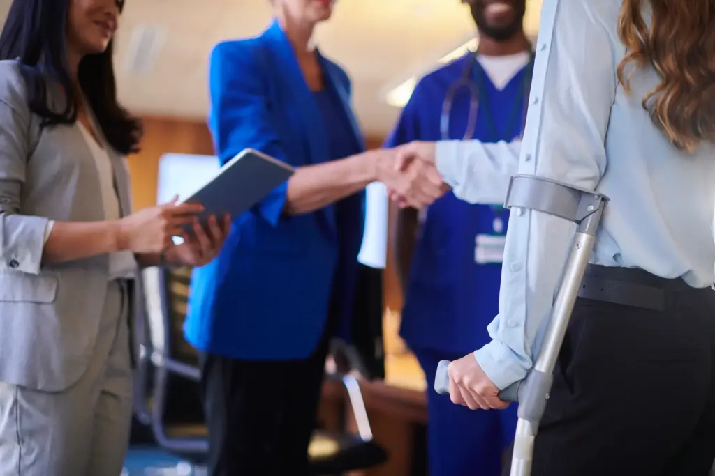 A injured victim shaking hands with people. 