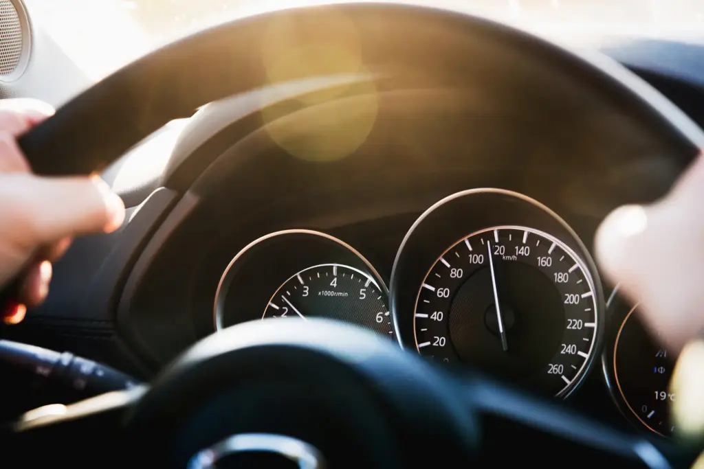 A driver speeding in his car. 