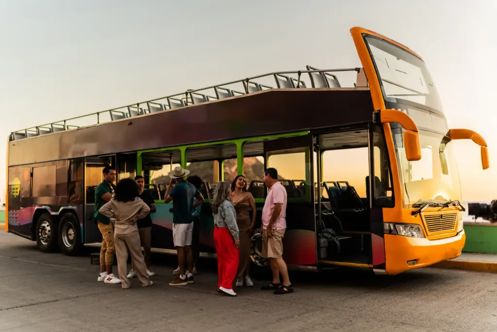 A group of people about to get onto a tour bus. 